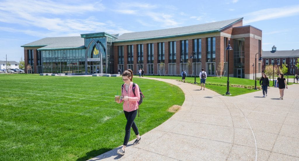 Students walk on the paths outside the Arthur F. and Patricia Ryan Center for Business Studies