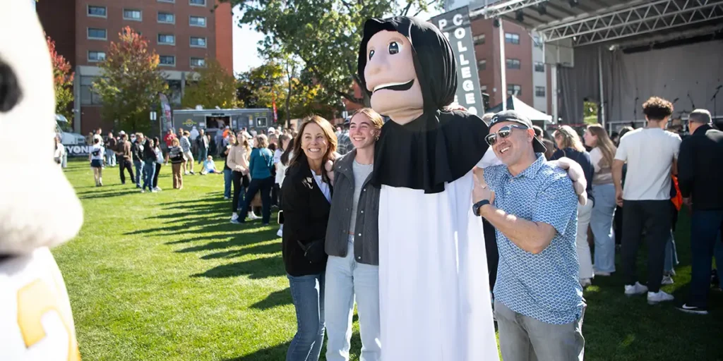 family with mascot at homecoming 2024